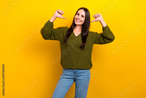 Tableau sur toile Photo of shiny adorable woman dressed khaki sweater pointing thumbs herself isol