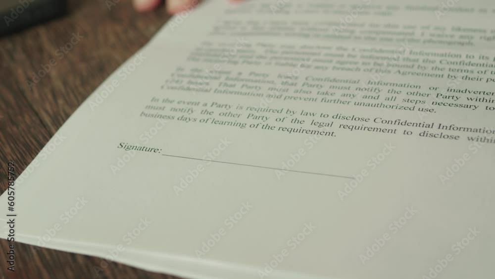 Contractor points where to put signature in the contract. Close up. Contractor points where to put signature in the contract. Close up.