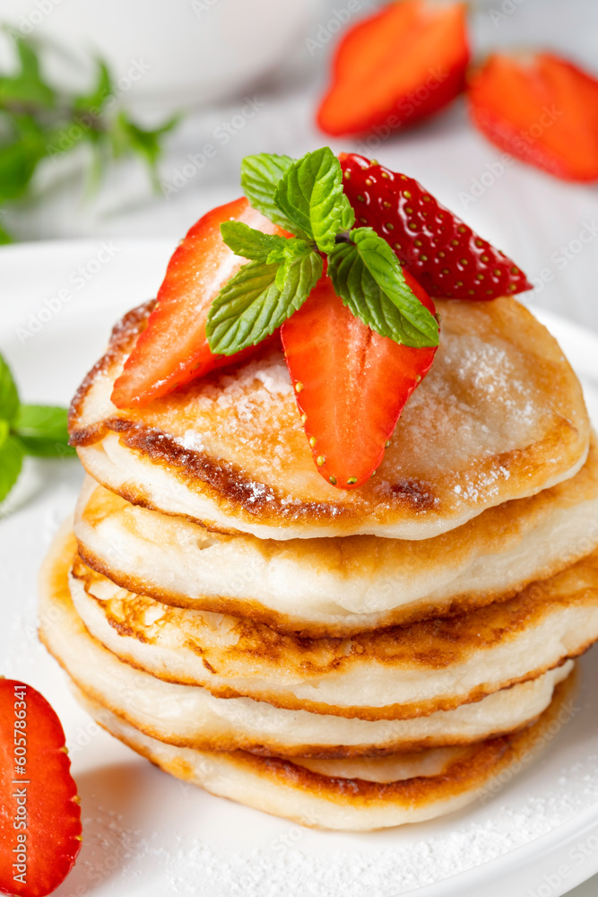 Yummy and fresh mini pancakes with strawberry for summer breakfast Yummy and fresh mini pancakes with strawberry for summer breakfast