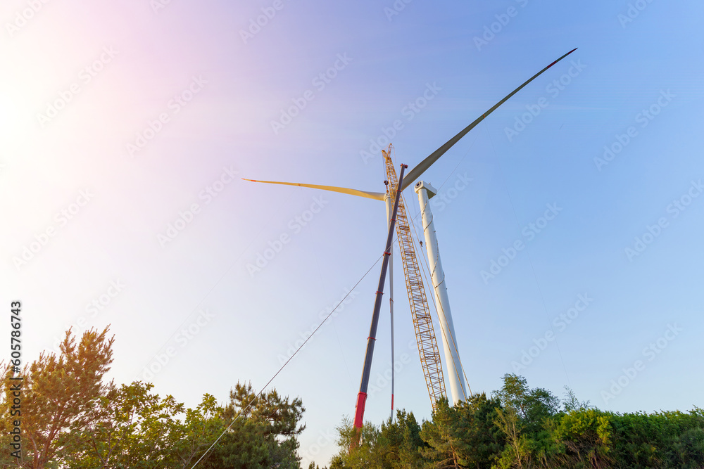 Fototapeta premium Wind turbines being hoisted and under construction