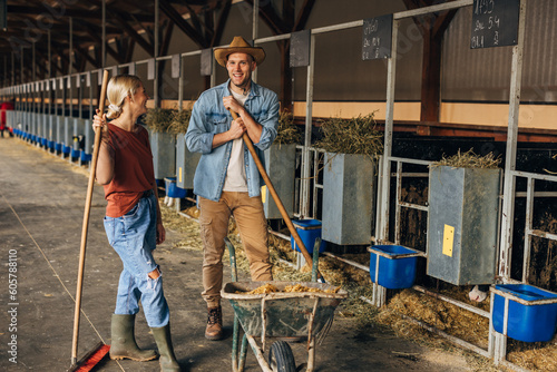 Two young adults working in a diary farm.
