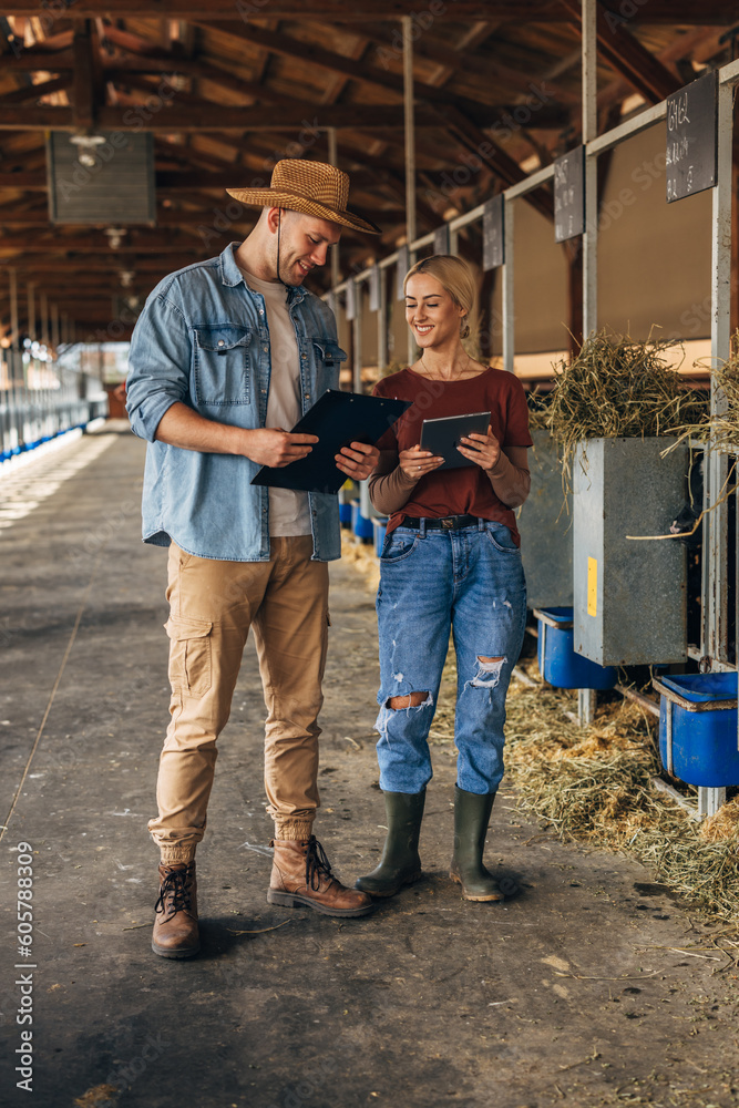 A man and a woman standing in a stall.