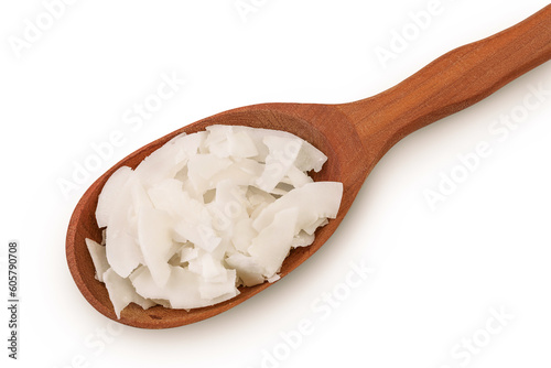 Coconut flakes or chips in wooden spoon isolated on white background. Top view. Flat lay