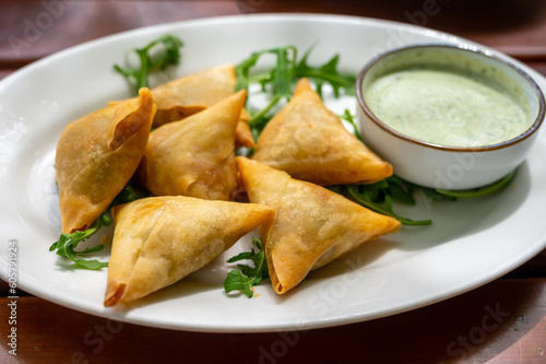 Traditional Middle East snack fried stuffed samosa pie with vegetables served with mint sauce