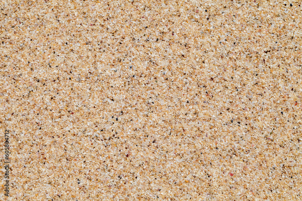 Background yellow beach sand from crushed seashells close-up Background yellow beach sand from crushed seashells close-up