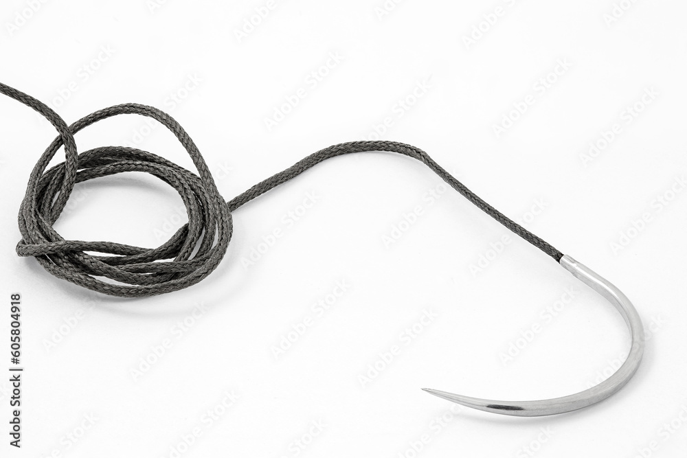 Surgical curved needle with thread, medical suture material, close-up, on white background Surgical curved needle with thread, medical suture material, close-up, on white background