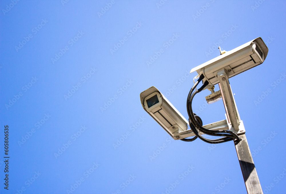 Surveillance cameras against the sky. Surveillance cameras, security. Video recording, security of objects. Surveillance cameras against the sky. Surveillance cameras, security. Video recording, security of objects.
