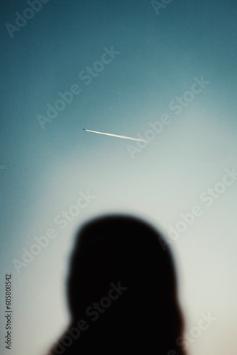 silhouette of a person with a plane (ID: 605808542)