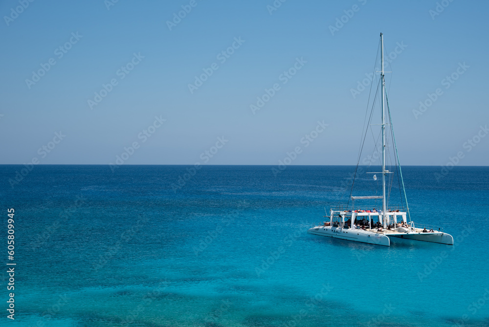 Tourist yacht sailing in the sea with tourists enjoying summer holidays. Summer vacations. Cape Grego Cyprus