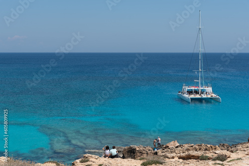Tourist yacht sailing in the sea with tourists enjoying summer holidays. Summer vacations. Cape Grego Ayia Napa Cyprus