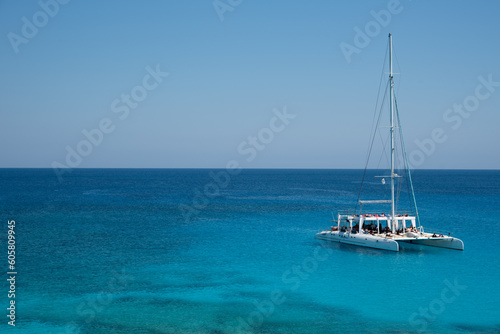 Tourist yacht sailing in the sea with tourists enjoying summer holidays. Summer vacations. Cape Grego Cyprus