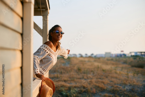 Принти на полотні Young carefree woman enjoying on patio at sunset.