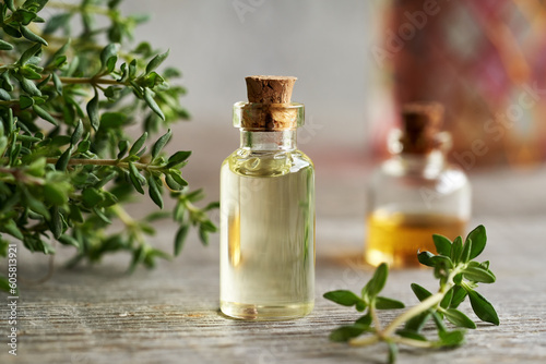 A bottle of thyme essential oil on a table
