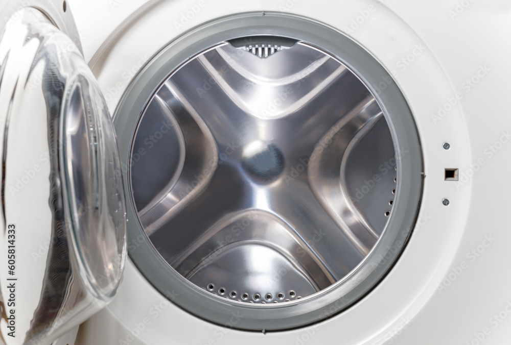 Inside of washing machine. Rotating inner tub. Material metal. Close-up of electrical household appliance. Inside of washing machine. Rotating inner tub. Material metal. Close-up of electrical household appliance.