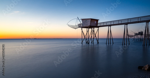 Fishing hut on stilts coast of Atlantic ocean at sunset near La Rochelle, Charente Maritime, France