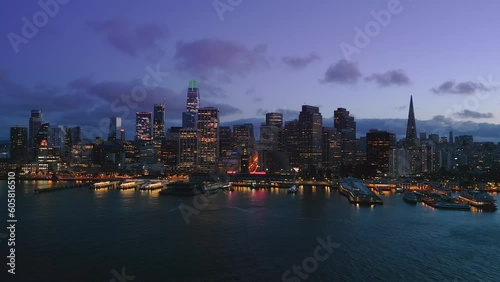 Wallpaper Mural Amazing Arial view Of The San Francisco City Skyline and Ferry Terminal during gorgeous sunset time. Purple sky and clouds behind the nighttime skyscrapers. SF, California. USA Torontodigital.ca