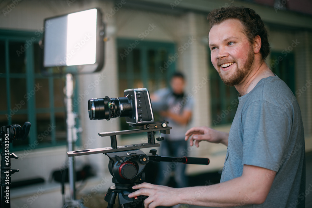 Director of photography with a camera in his hands on the set. The filming process on the street, on location