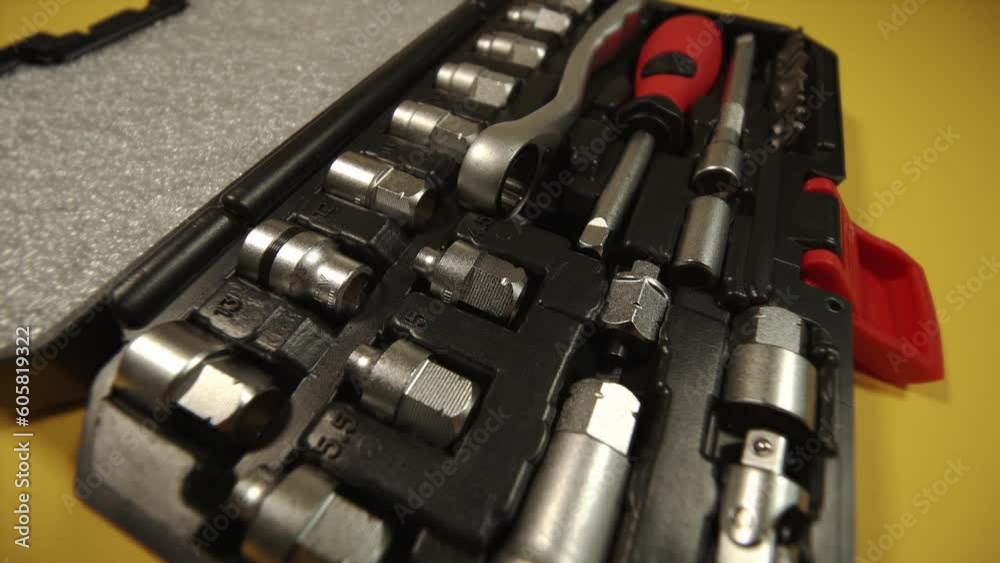 open toolbox with screwdriver wrenches and heads on yellow open toolbox with screwdriver wrenches and heads on yellow