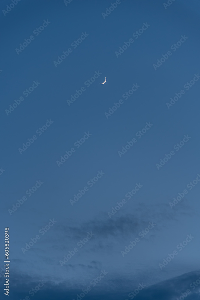 Waxing Crescent Moon and Venus on the sky during the blue hour