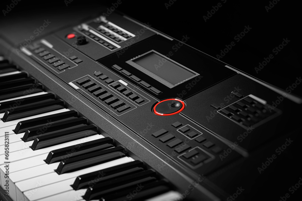 Keyboard synthesizer on a dark background. Electric piano close-up. Keyboard synthesizer on a dark background. Electric piano close-up.