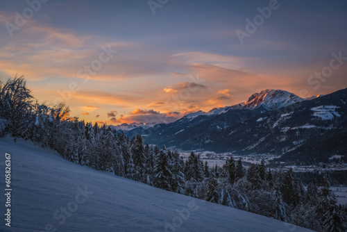 Fototapeta Naklejka Na Ścianę i Meble -  Alpenglow at sunset time on mountain peak at Nassfeld ski resort, Carinthia, Austria. January 2022