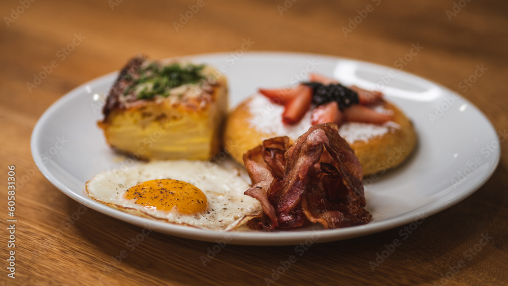 tasty waffle breakfast with fruits, bacon, egg and potato soufflé tasty waffle breakfast with fruits, bacon, egg and potato soufflé