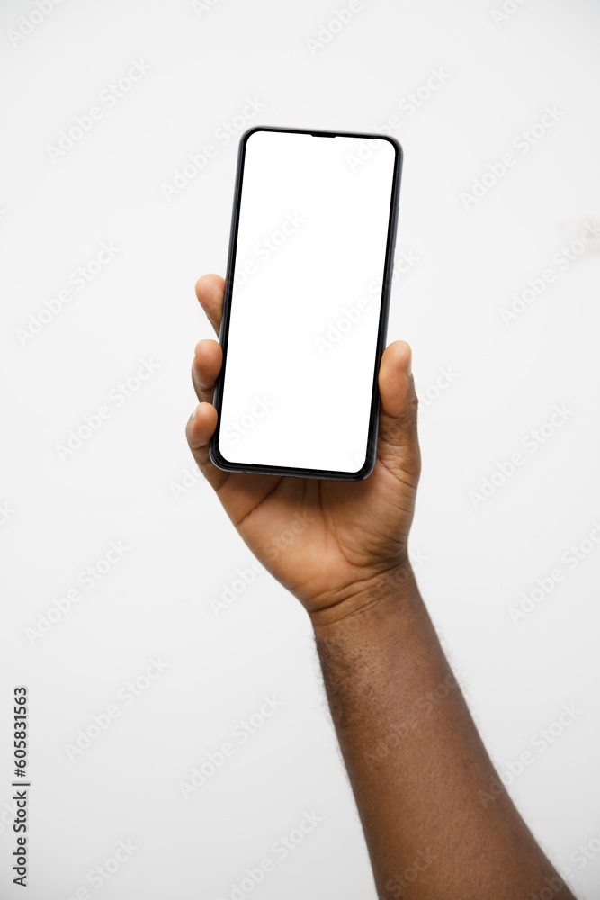Black hand holding phone facing camera isolated on white background. blank screen, phone screen mockup, front view, clipping path, clipping mask Black hand holding phone facing camera isolated on white background. blank screen, phone screen mockup, front view, clipping path, clipping mask