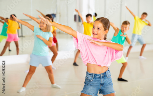 Dance class for kids, positive girls and boys training in dance studio