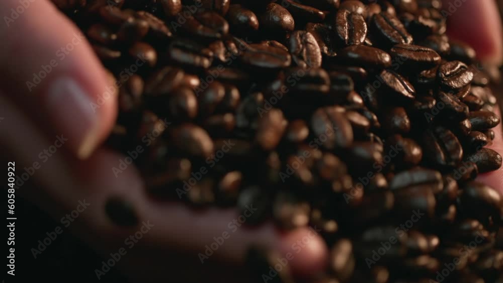 Caucasian Hands Scooping Coffee Beans In Coffee Bean Pile, Slow Motion. Shot with ARRI Alexa in ArriRaw at 120 fps and exported 23.98 fps, QuickTime Apple ProRes 422 HQ.