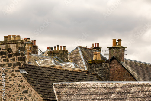 slate roofs and chimmneys with pots in a mostly victorian era scottish village room for text photo