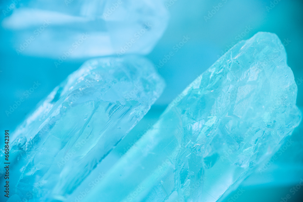 Rock crystal macro texture in blue light.transparent quartz crystals background in blue tones.texture of gemstone. crystals of natural transparent stone rock.Texture of natural stone Rock crystal Rock crystal macro texture in blue light.transparent quartz crystals background in blue tones.texture of gemstone. crystals of natural transparent stone rock.Texture of natural stone Rock crystal