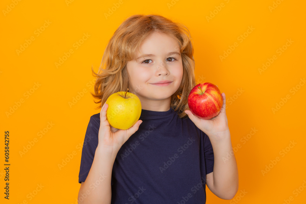 Apples. Kid with apple in studio. Studio portrait of cute child hold apple isolated on yellow background. Apples. Kid with apple in studio. Studio portrait of cute child hold apple isolated on yellow background.