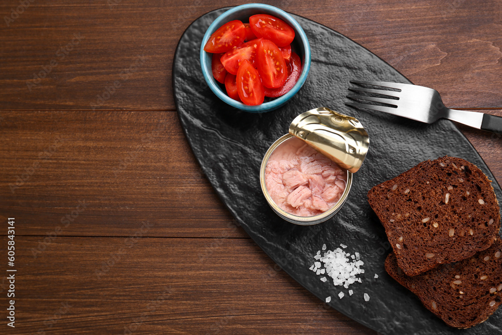 Can of conserved tuna, tomatoes and bread on wooden table, top view. Space for text Can of conserved tuna, tomatoes and bread on wooden table, top view. Space for text