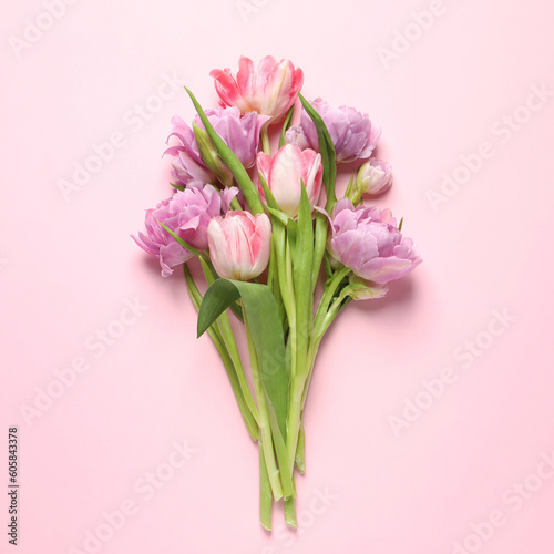 Beautiful colorful tulip flowers on pink background, top view