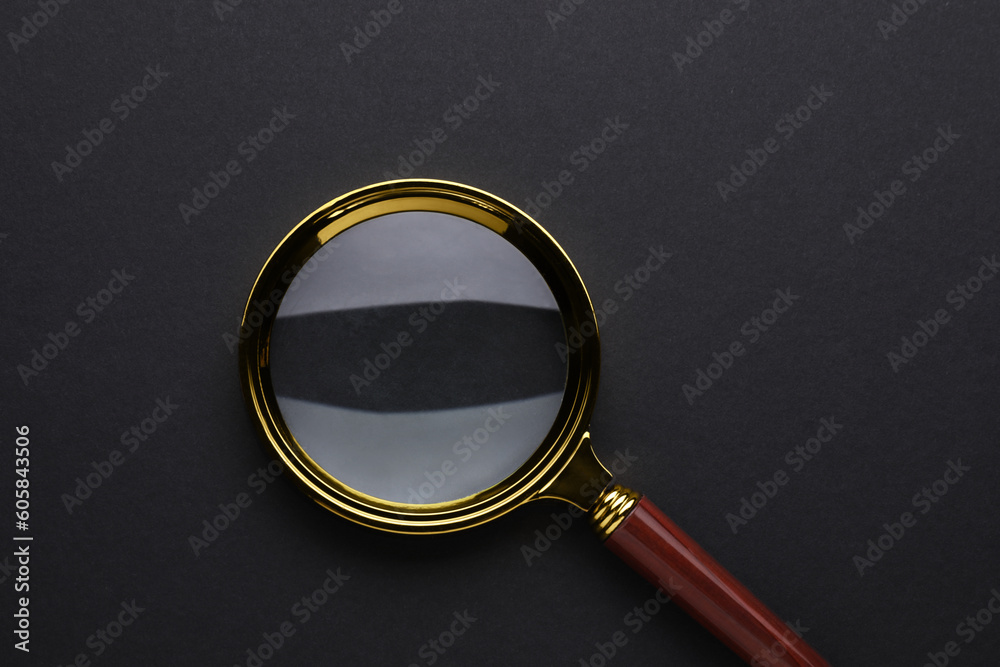 Magnifying glass on dark background, top view Magnifying glass on dark background, top view