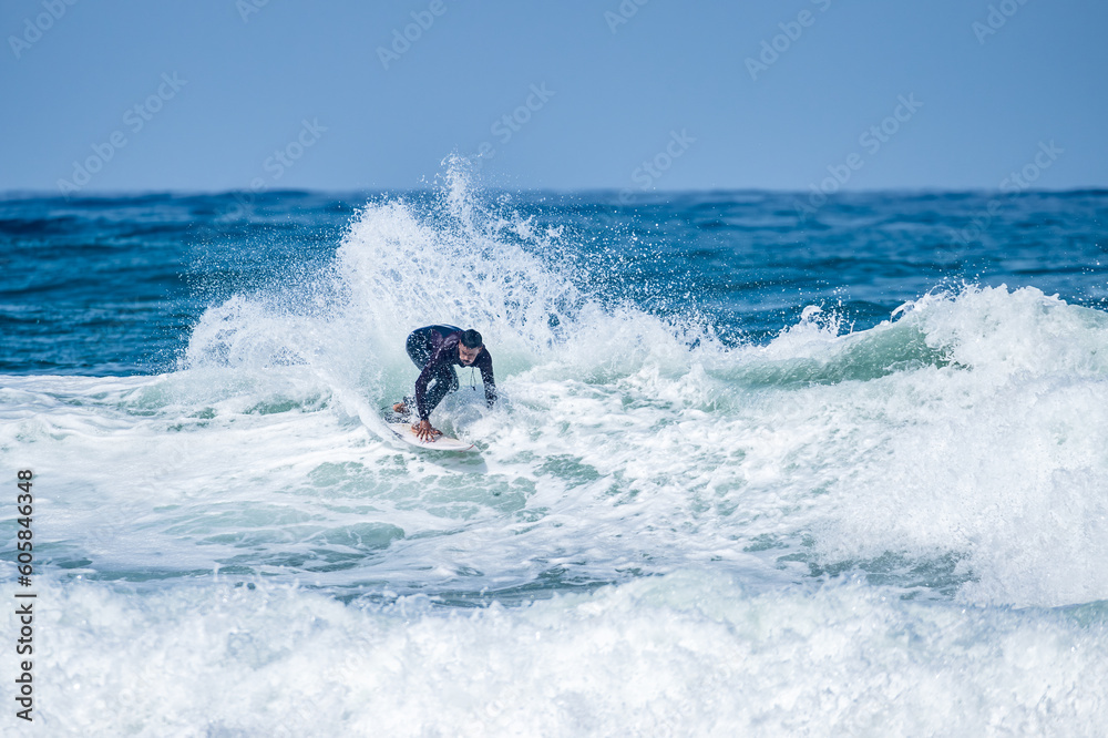 Surfer riding waves in Furadouro Beach Surfer riding waves in Furadouro Beach