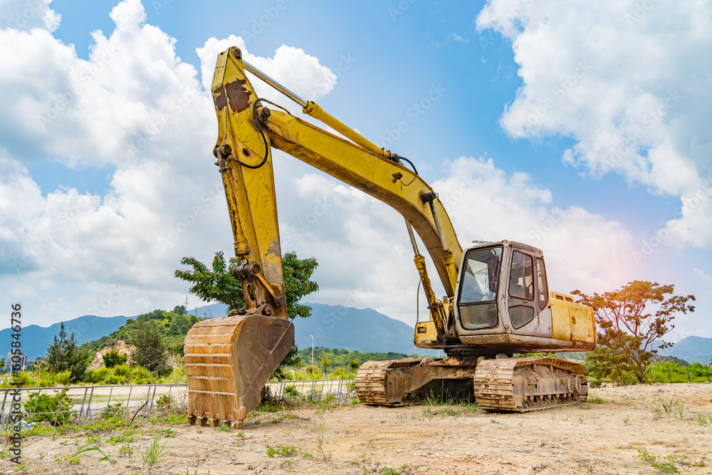 Heavy earth mover with blue sky in the background Heavy earth mover with blue sky in the background