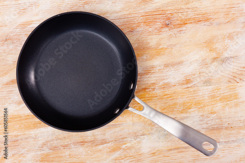 Small black frying pan having nonstick surface and practical long handle