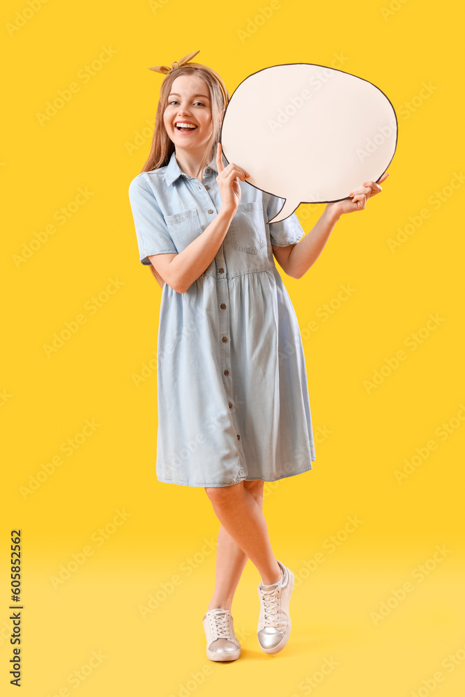 Happy young woman with blank speech bubble on yellow background Happy young woman with blank speech bubble on yellow background