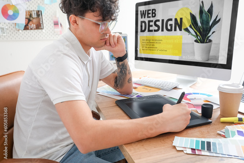 Male graphic designer worki...