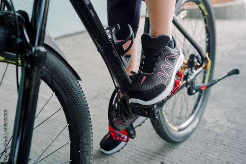  Photo of a girl doing bicycle exercise, and wearing sports shoes 