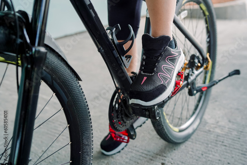  Photo of a girl doing bicycle exercise, and wearing sports shoes   