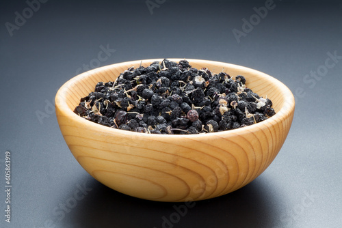 black Chinese wolfberry in a wooden bowl