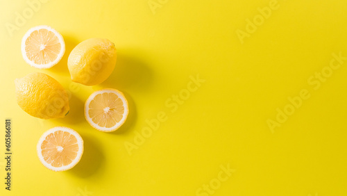 Summer composition made from oranges, lemon or lime on pastel yellow background. Fruit minimal concept. Flat lay, top view, copy space.