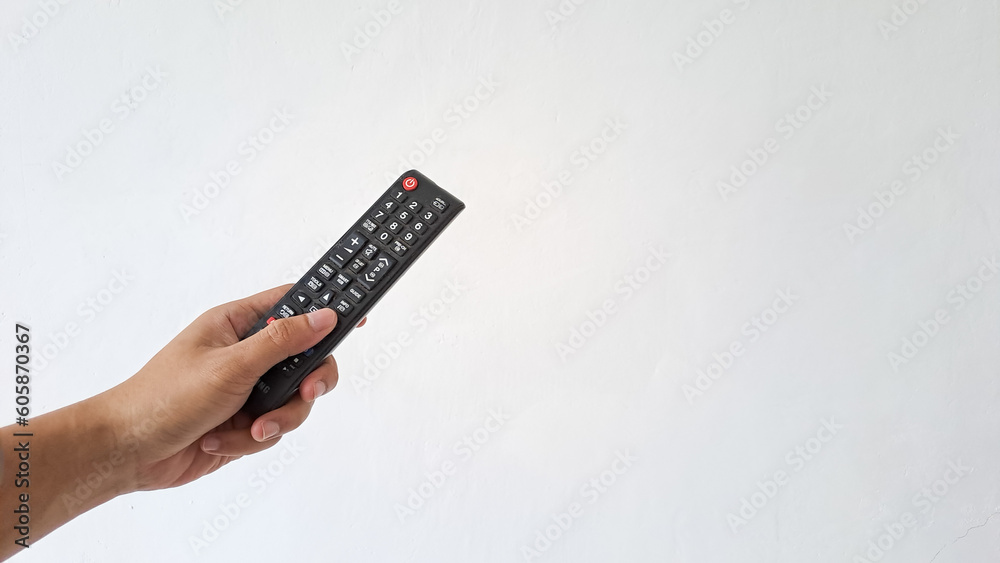 Man's Hand holding television remote control isolated on white background Man's Hand holding television remote control isolated on white background
