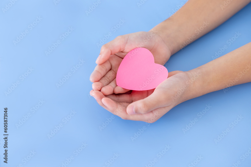 Closeup,Child's hands with a red heart on blue background.Give love philanthropy,help warmth and take care,protect children's health,blood donation and stem cell,valentines day concept.Space for text. Closeup,Child's hands with a red heart on blue background.Give love philanthropy,help warmth and take care,protect children's health,blood donation and stem cell,valentines day concept.Space for text.