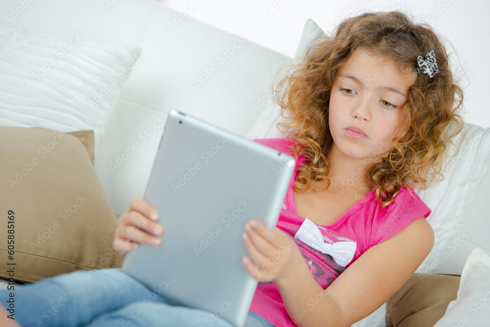 a young girl holding tablet a young girl holding tablet