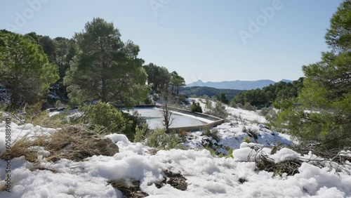 Snow-covered pine mountain on a sunny day - Mariola, Alicante, Spain photo