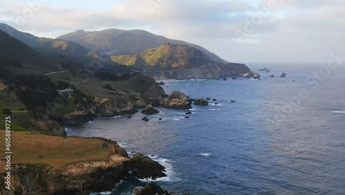 Aerial Cinematic drone early spring coastline Big Sur Rock Creek Bixby Bridge coastal Highway 1 vista point California early sunrise sunset morning stunning rugged deep blue ocean backward motion photo