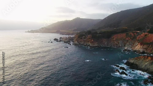 Aerial Cinematic drone early spring coastline Big Sur Rock Creek Bixby Bridge coastal Highway 1 vista point California early sunrise sunset morning stunning rugged deep blue ocean forward up motion photo